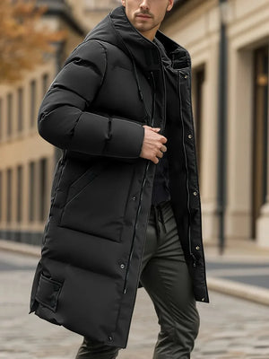 Man wearing a black puffer jacket in an urban setting