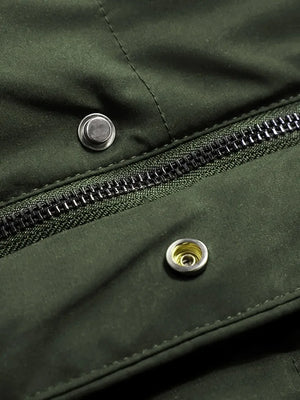 Close-up of a green jacket with a zipper and buttons.