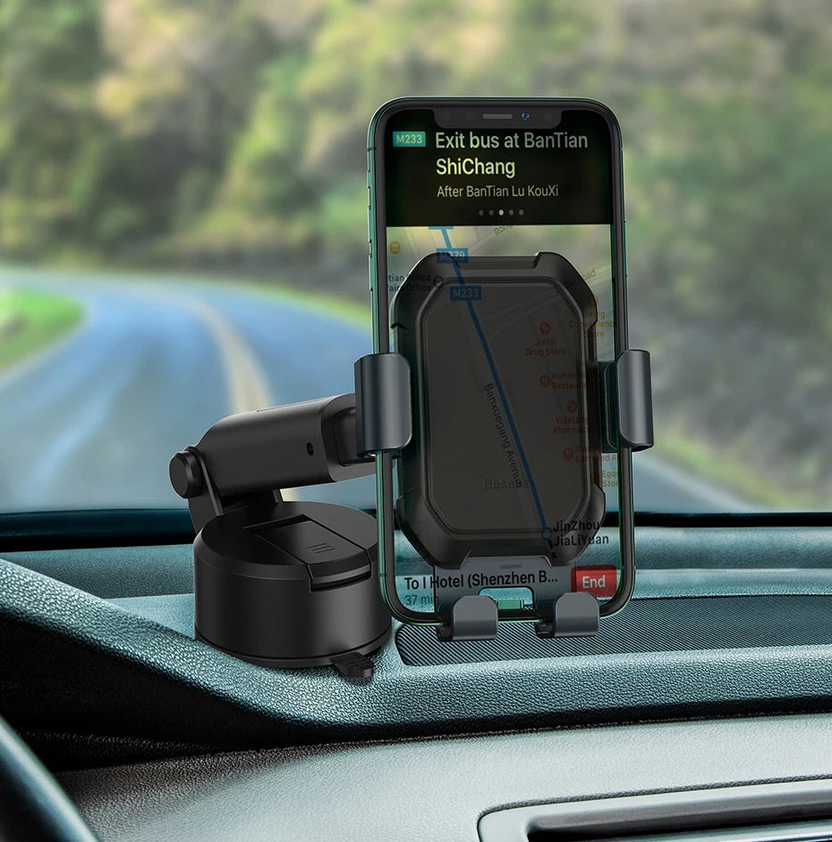 Phone mounted on a car dashboard with a GPS app displayed, with a blurred road and trees in the background.