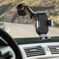Car phone holder mounted on a car dashboard with a scenic road in the background