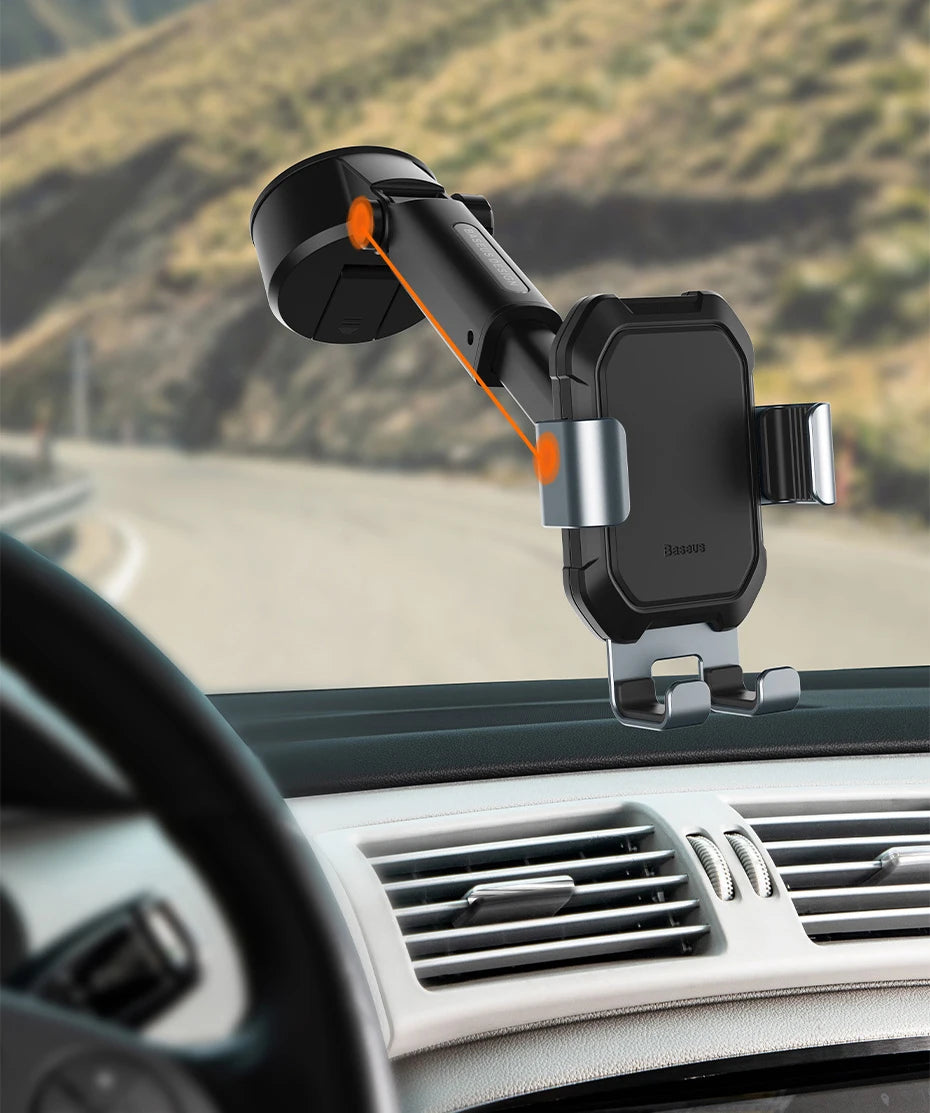 Car phone holder mounted on a car dashboard with a scenic road in the background