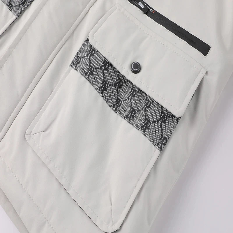 Close-up of a light gray jacket with a patterned pocket flap on a white background