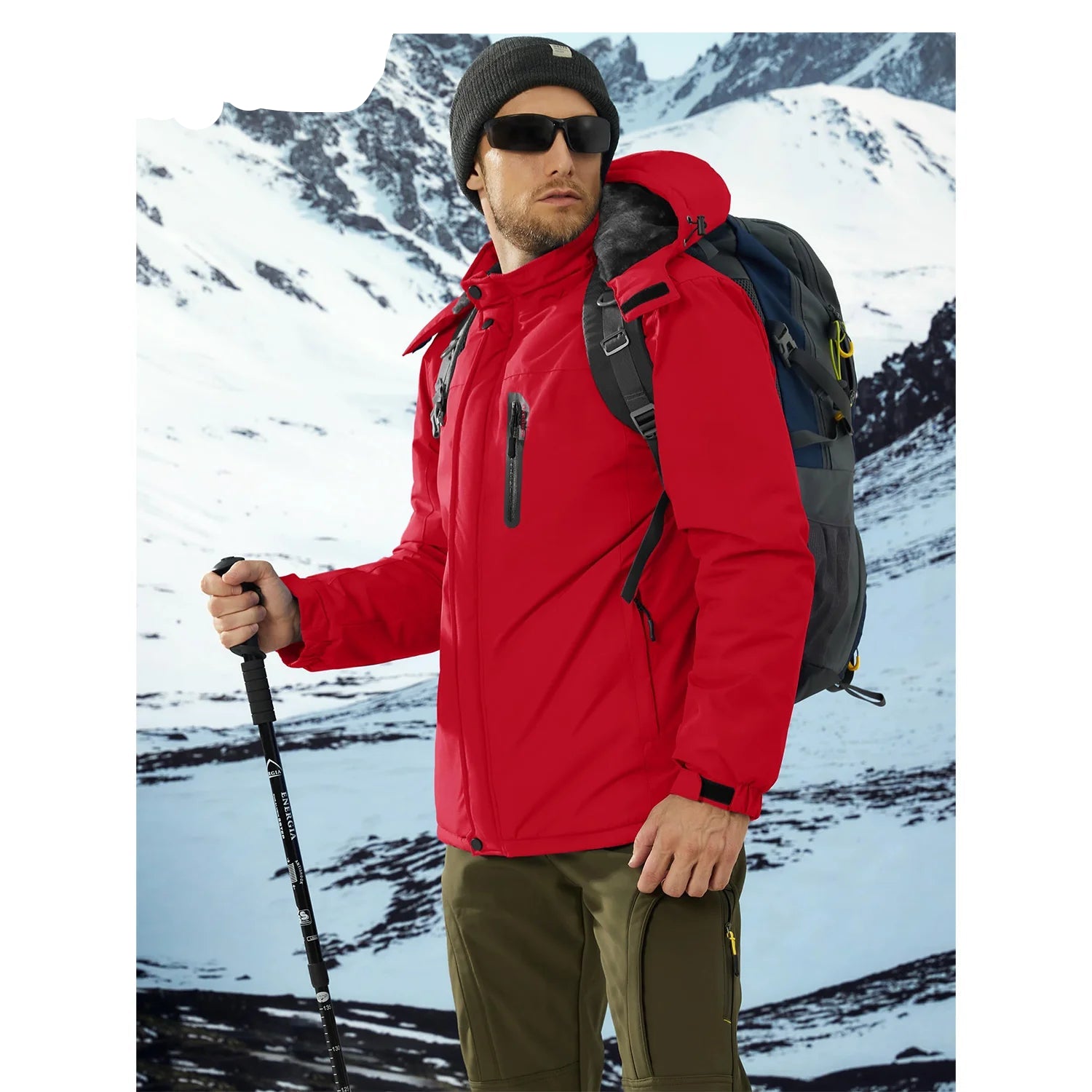 Man in a red jacket with a backpack and hiking poles in a snowy mountain setting, featuring the en brand.