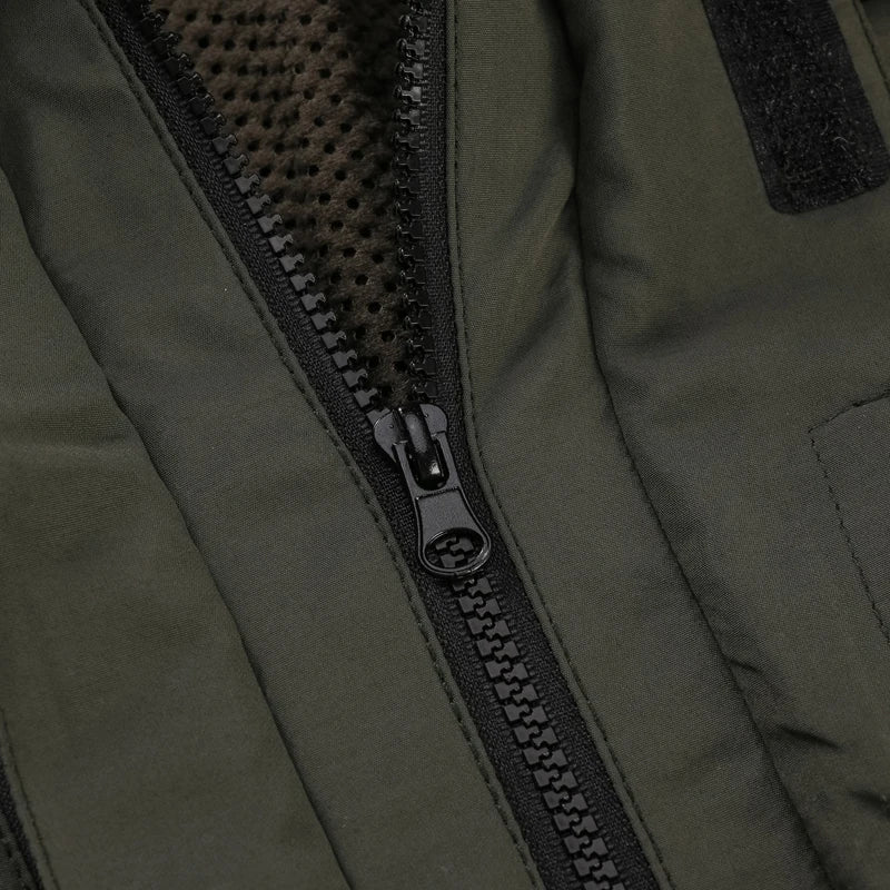 Close-up of a zipper on a green jacket with a textured inner lining.