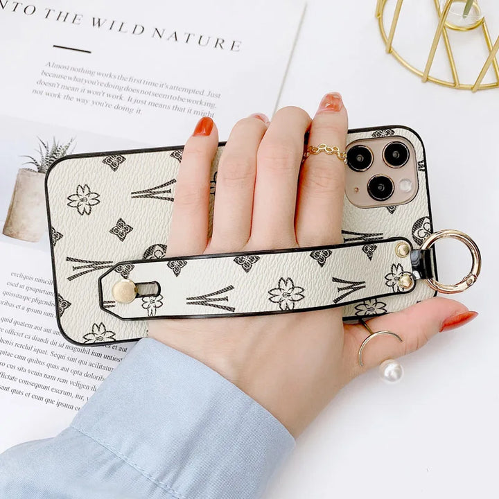 Luxury leather wristband phone case for iPhone, featuring jeweled and fabric designs, durable and stylish.