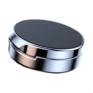 Round metallic object with a reflective surface on a white background