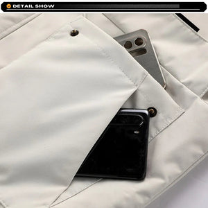 Smartphone in a white shirt pocket with visible brand logo.
