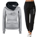 Gray hoodie and black jogger pants with heart design on a white background