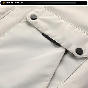 Close-up of a light gray jacket with black buttons and zipper