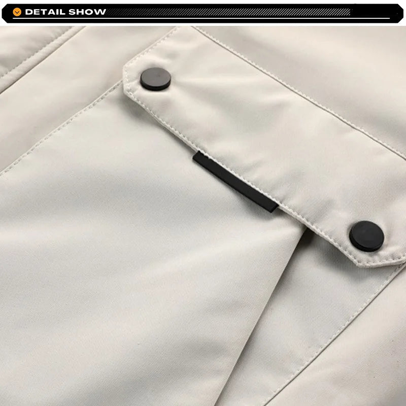 Close-up of a light gray jacket with black buttons and zipper