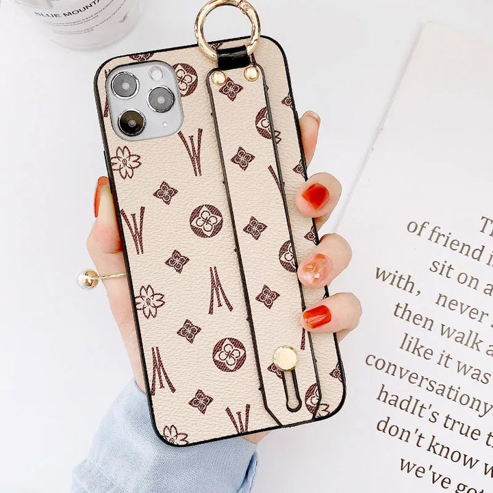 Luxury leather wristband phone case for iPhone, featuring jeweled and fabric designs, durable and stylish.