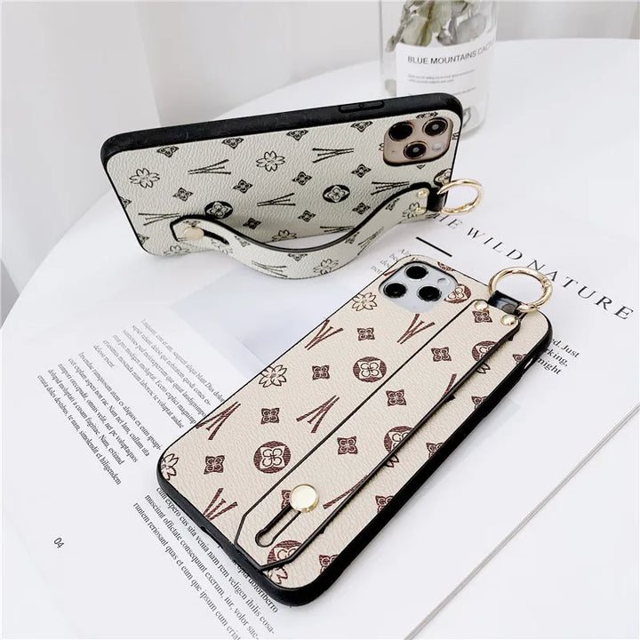 Luxury leather wristband phone case for iPhone, featuring jeweled and fabric designs, durable and stylish.