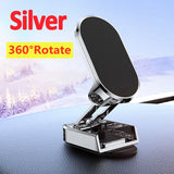 Silver 360-degree rotate phone holder on a car dashboard with snowy landscape background