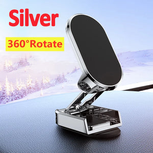 Silver 360-degree rotate phone holder on a car dashboard with snowy landscape background