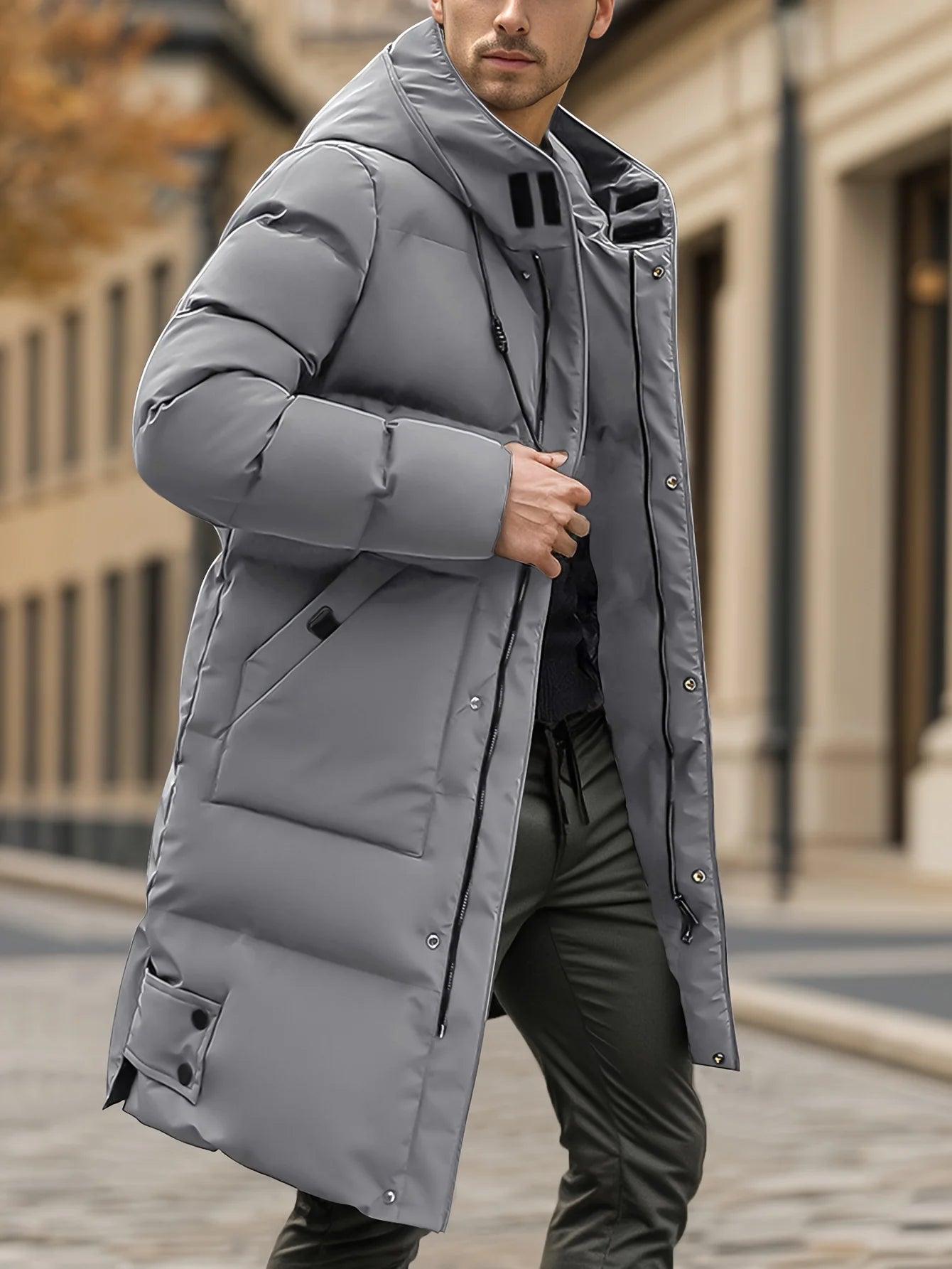 Person wearing a gray winter coat on a city street.
