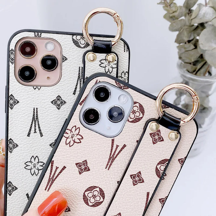 Luxury leather wristband phone case for iPhone, featuring jeweled and fabric designs, durable and stylish.
