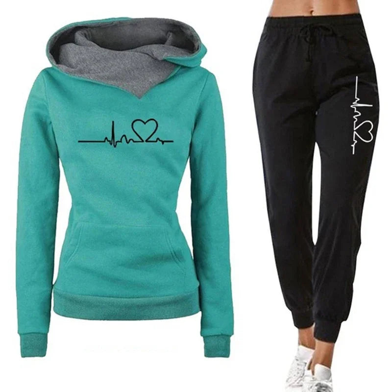 Teal hoodie with heart and line design and black jogger pants on a white background